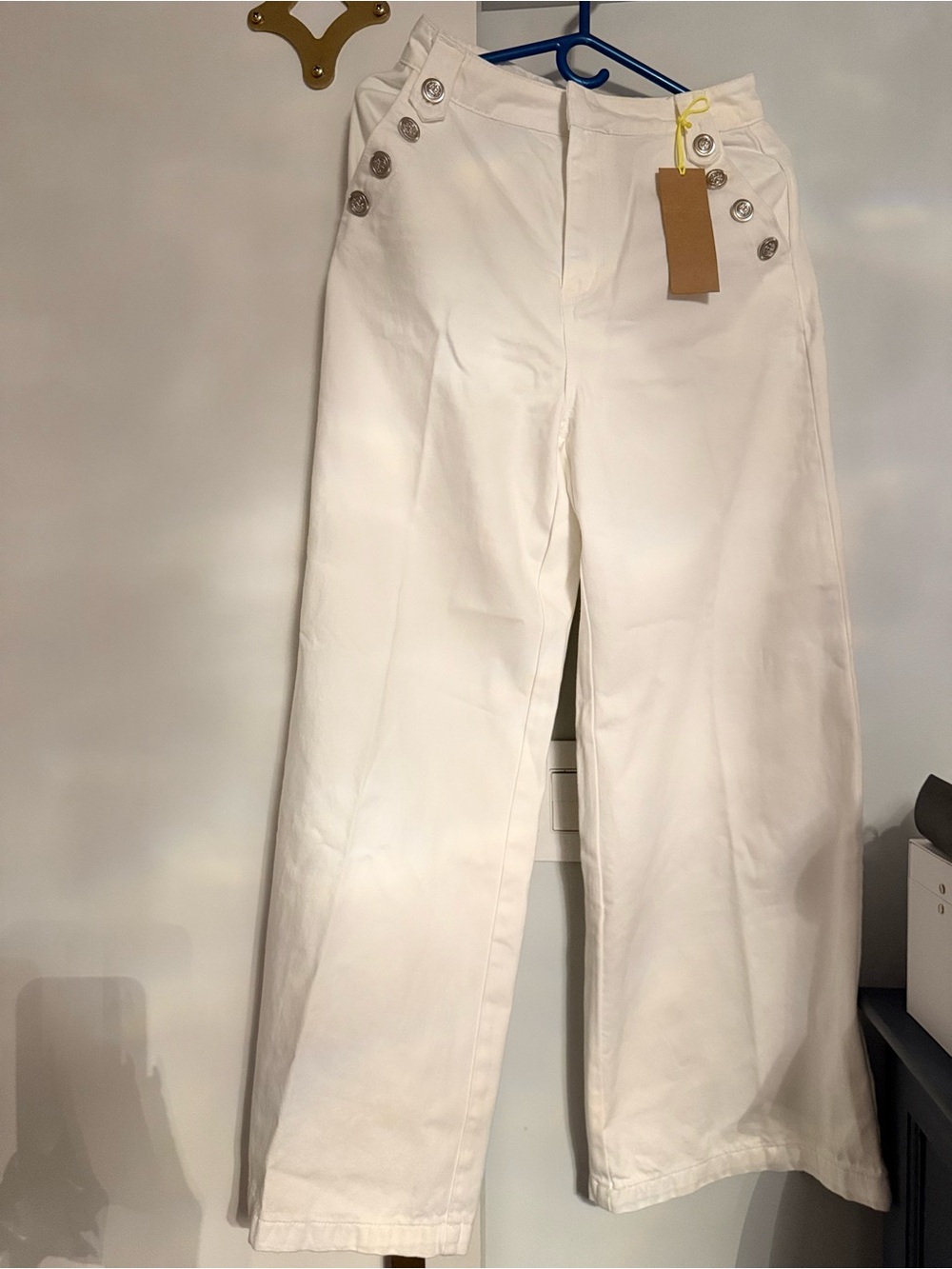 High-Waist Wide-Leg White Jeans with Decorative Buttons and matching vest.